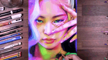 a drawing of a woman 's face is surrounded by colored pencils