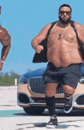 a fat man is running in front of a car