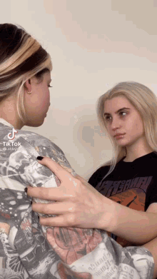 two girls are looking at each other and one has a t-shirt that says greenpeace on it
