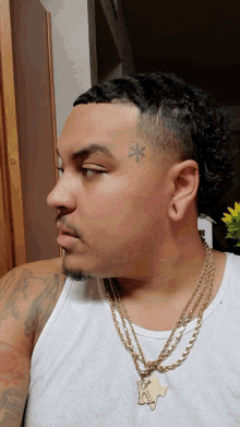 a man with a tattoo on his forehead and a texas necklace