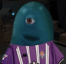 a blue balloon with a purple shirt on is wearing a purple shirt with a third eye .
