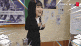 a woman in a suit is standing in front of a drum set and a sign that says free fire x