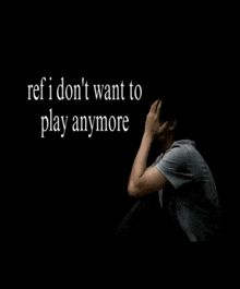 a man sits in a dark room with the words ref i don 't want to play anymore behind him