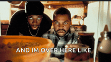 two men looking into a refrigerator with the words " and im over here like " on the bottom