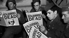 a group of soldiers reading benjamins dead newspapers