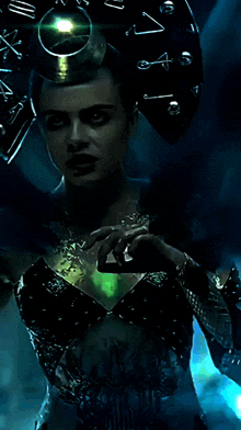 a woman in a costume with a clock on her head holds a green object