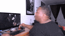 a man is sitting in front of a samsung computer