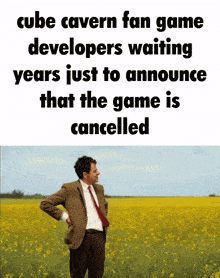 a man in a suit and tie stands in a field of flowers