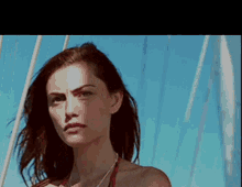 a woman in a red bikini is standing on a boat