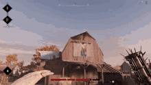 a screenshot of a video game shows a person holding a gun in front of a wooden barn