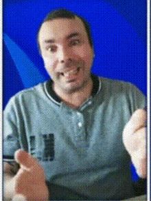 a man wearing a grey shirt with the letter n on the front