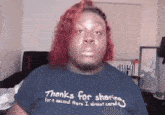 a woman wearing a blue shirt that says thanks for sharing