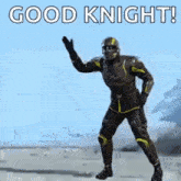 a man in a superhero suit is dancing and waving his hand .