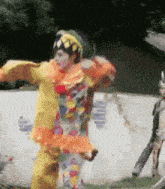 a person in a clown costume is dancing in front of a wall that says ' aquafina '