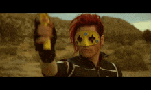 a man with red hair is wearing a yellow mask and holding a banana