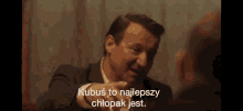 a man in a suit is talking to another man with a caption that says kubus to najlepszy chłopak jest