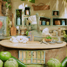 a stuffed animal wearing a chef 's hat and apron is standing on a table