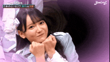 a girl is making a face with her hands on her chin in front of a sign that says ' stand on 2 '
