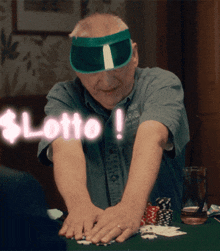 a man wearing a green visor is playing poker with the word lotto behind him
