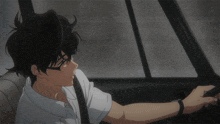 a young man wearing glasses is driving a car in the rain