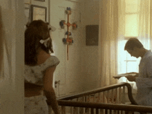 a man and a woman are standing next to each other in a room .