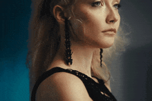 a close up of a woman 's face with earrings on