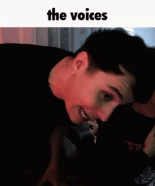 a close up of a person 's face with the words " the voices " above it