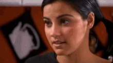 a close up of a woman 's face with a black shirt on .