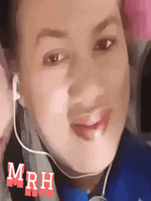 a woman wearing ear buds has the word mrh written on her face