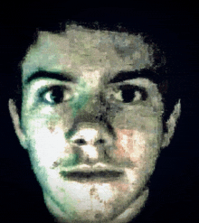 a pixelated image of a man 's face with a black background