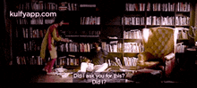 a woman is standing in front of a bookshelf asking did i ask you for this ?