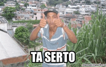 a man is giving a thumbs up in front of a city and says ta serto