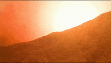 the sun is shining brightly over a mountain range