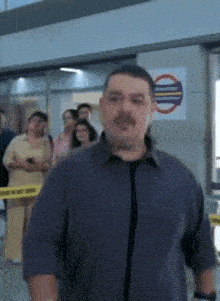 a man is standing in front of a sign that says " do not enter "