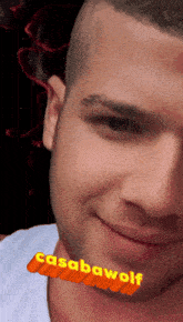 a close up of a man 's face with casabawolf written on the bottom right