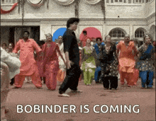 a group of people are dancing in a room with the words `` bobinder is coming '' written on the bottom .
