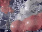 a bunch of red balloons hanging from a string