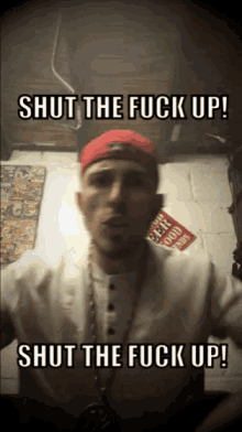 a man wearing a red hat and white shirt says shut the fuck up
