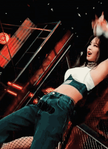 a woman in a crop top and fishnet stockings is laying down