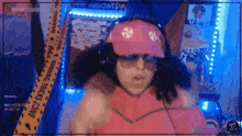 a woman wearing a pink hat and sunglasses is sitting in front of a warning tape that says halloween