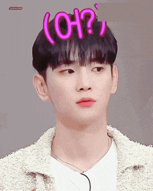 a close up of a young man 's face with the word oh written on his head