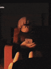 a person in a hoodie is holding an iphone