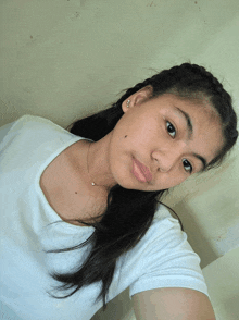 a girl taking a selfie with a white shirt