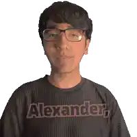 a man wearing glasses and a black shirt with the word alexander on it