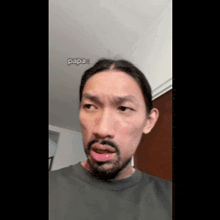 a man with a beard is making a funny face in a video .