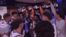 a group of basketball players in a locker room with the word humility on the wall behind them