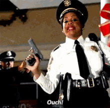 a police officer holds a gun and says ouch