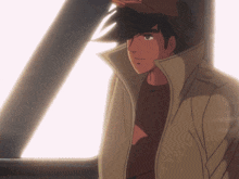 a man wearing a hat and a trench coat stands in front of a window