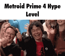 a man is giving a thumbs up in front of a group of people with the words metroid prime 4 hype level below him