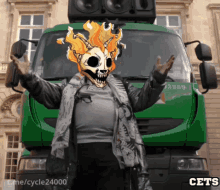 a person with a skull on their face stands in front of a green truck